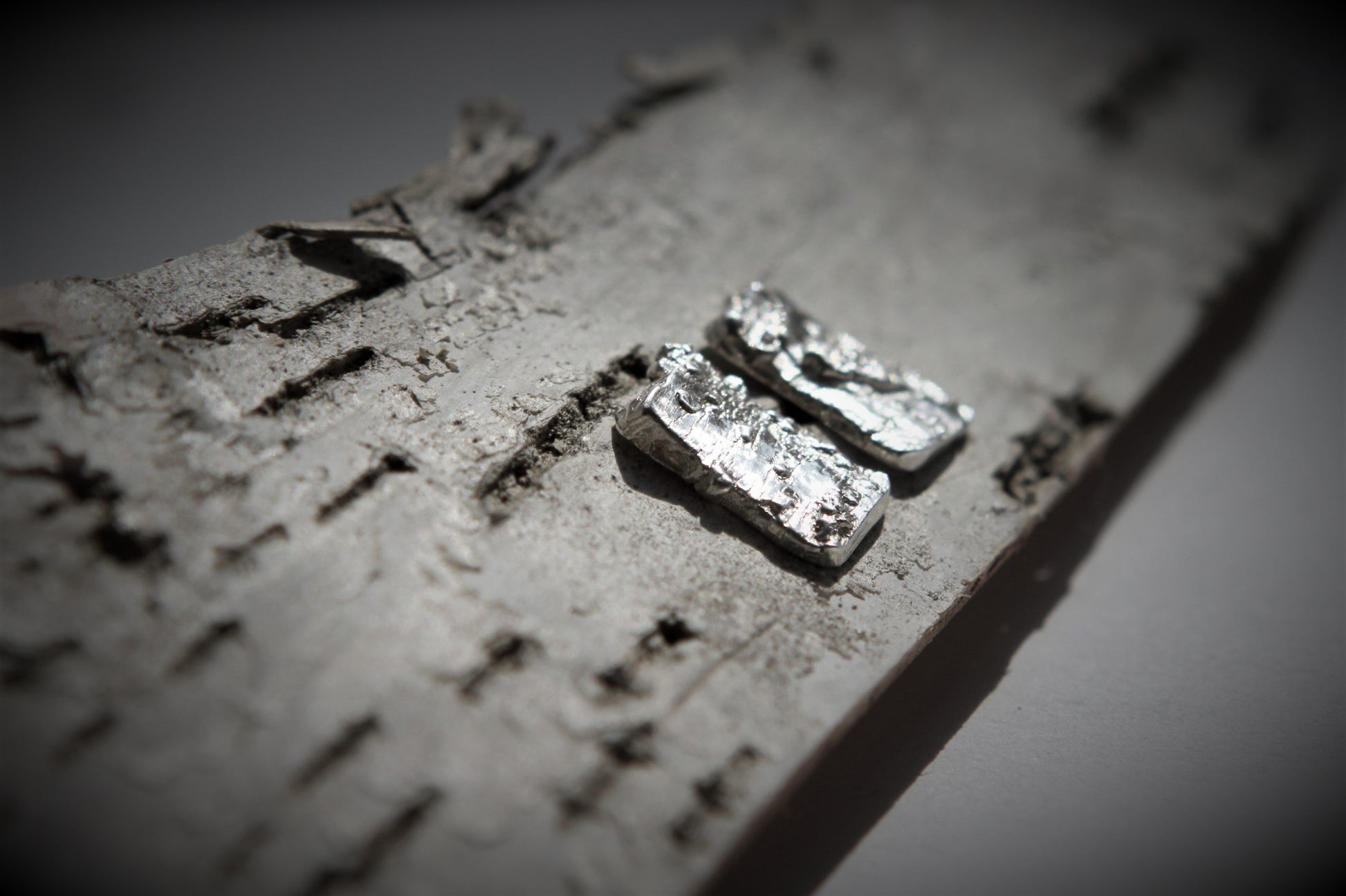 Earrings in a rectangular shape impressed with a genuine birch bark texture made of pure silver.  Each earring is approximately 10 mm long by 8 mm wide and have sterling silver ear posts and butterfly backs. 
